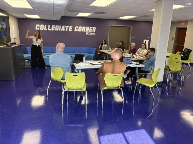 Staff listen to a presentation on Empowering Minds in the new Collegiate Corner