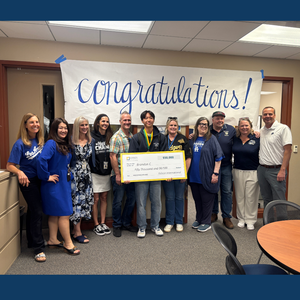 Group of West Ranch staff pose with Brandon Chang under a Congratulations banner