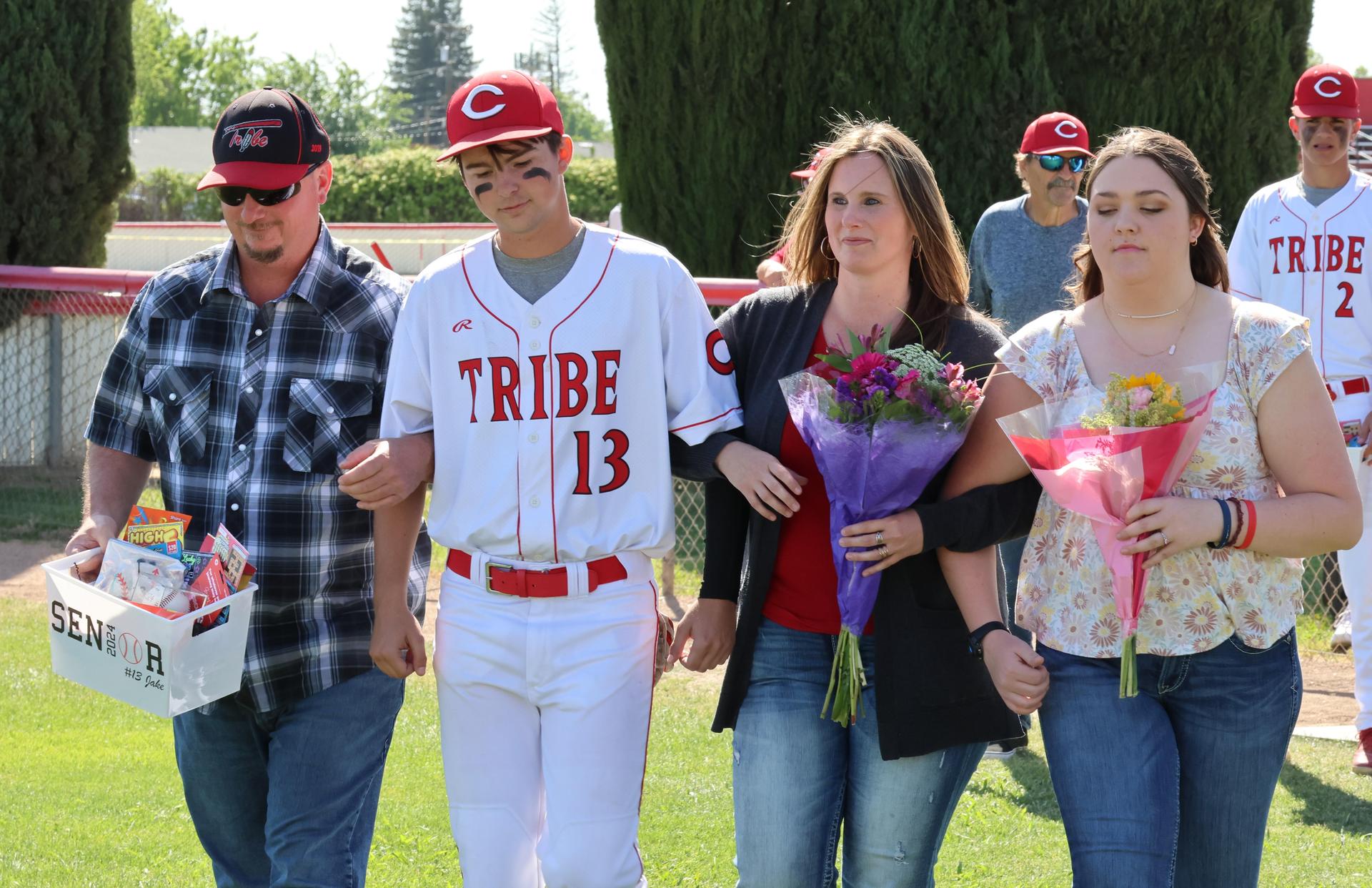 Seniors Posing With Teammates, Coaches, And Family