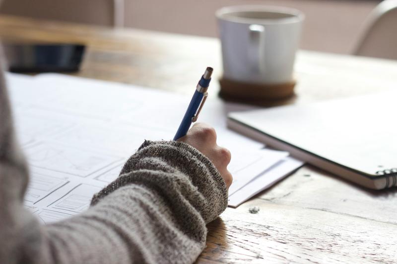 Person writing on a notepad.