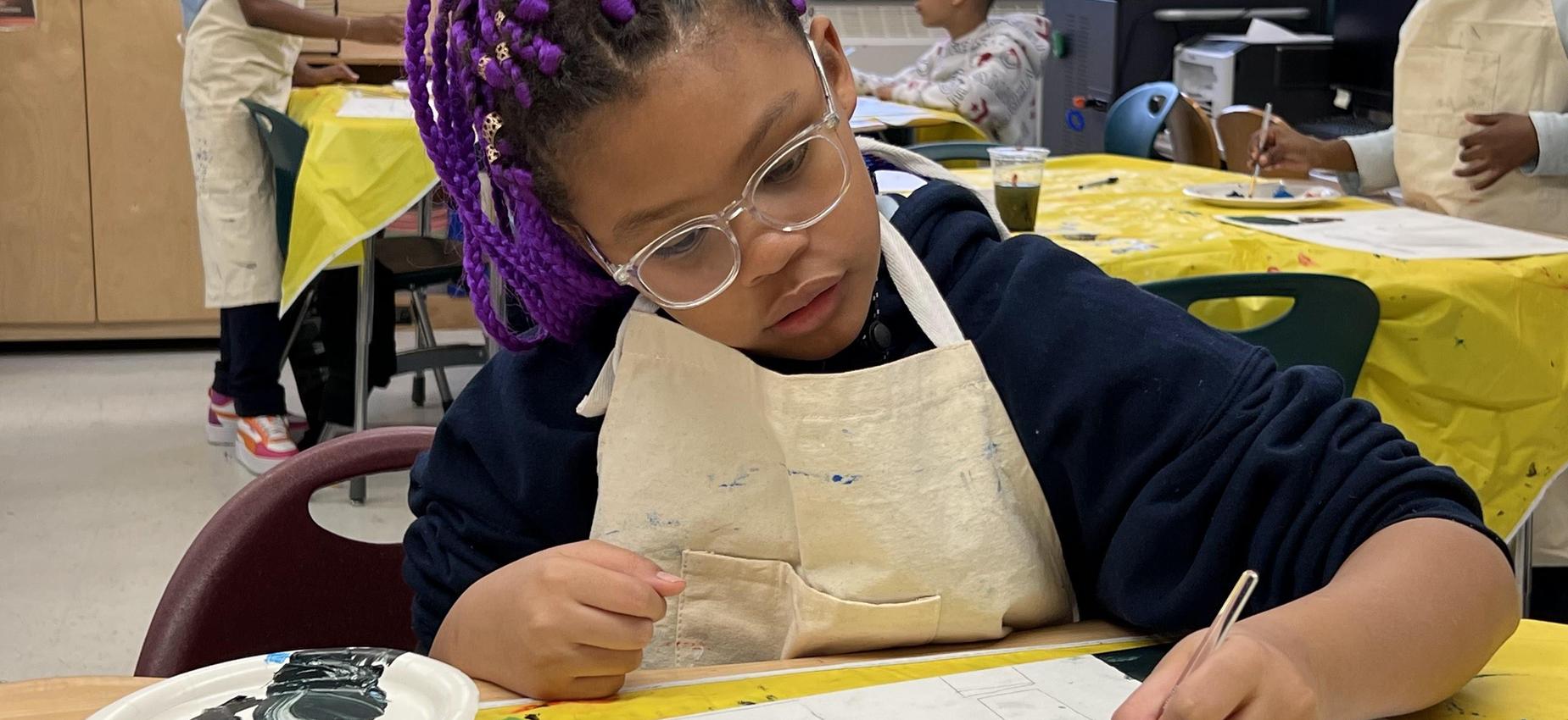 Girl painting in art room