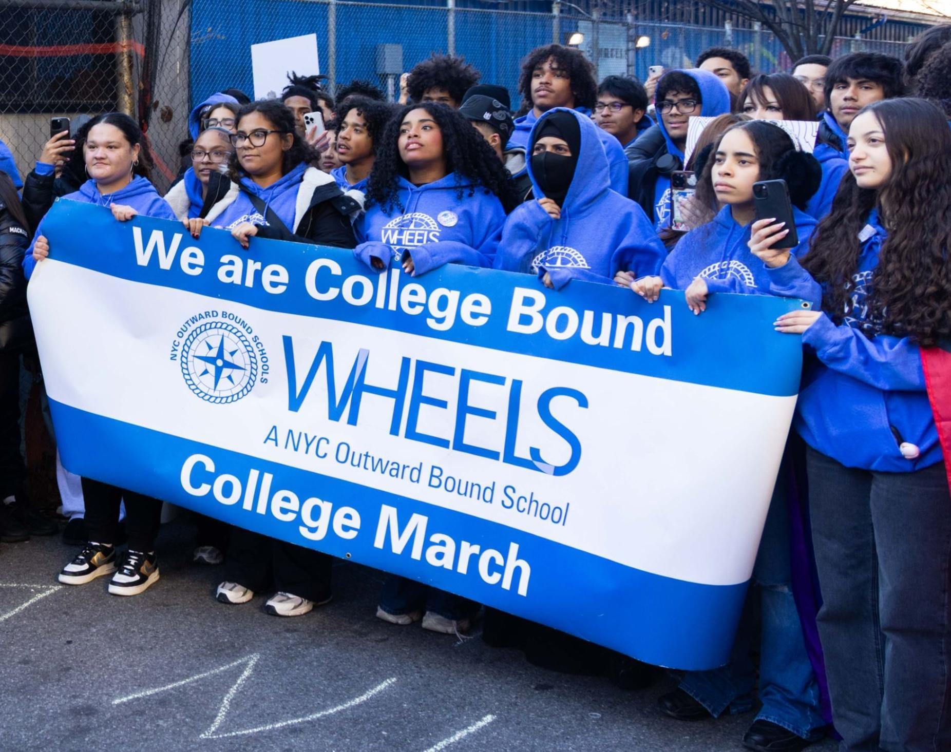 Students holding school banner