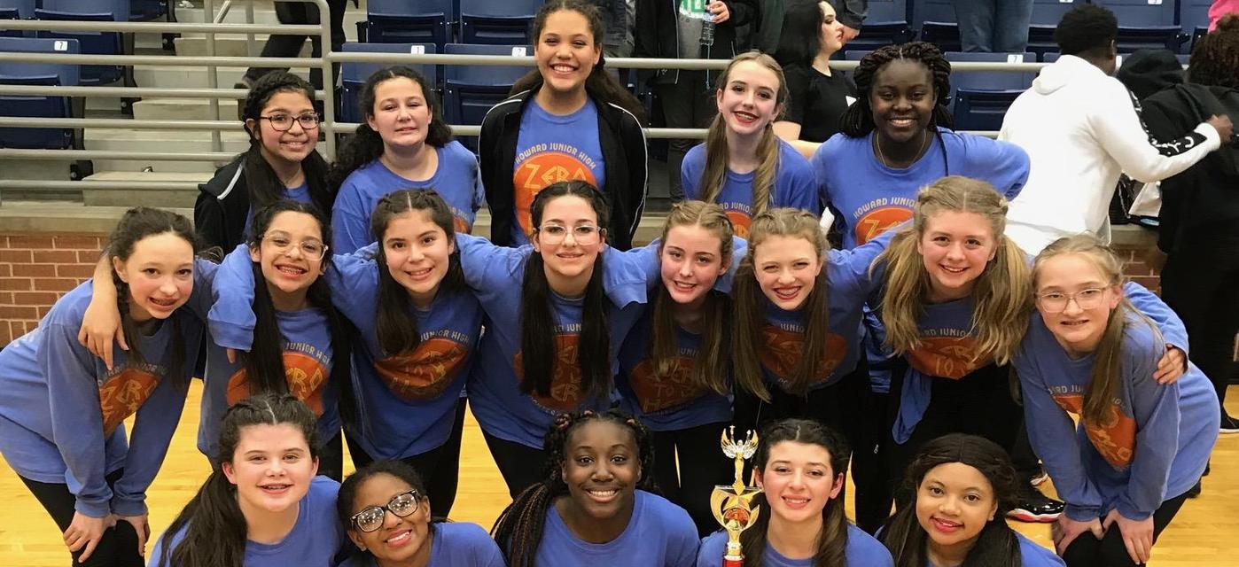 CheyAnnes Drill Team pose together with awards they earned at competition