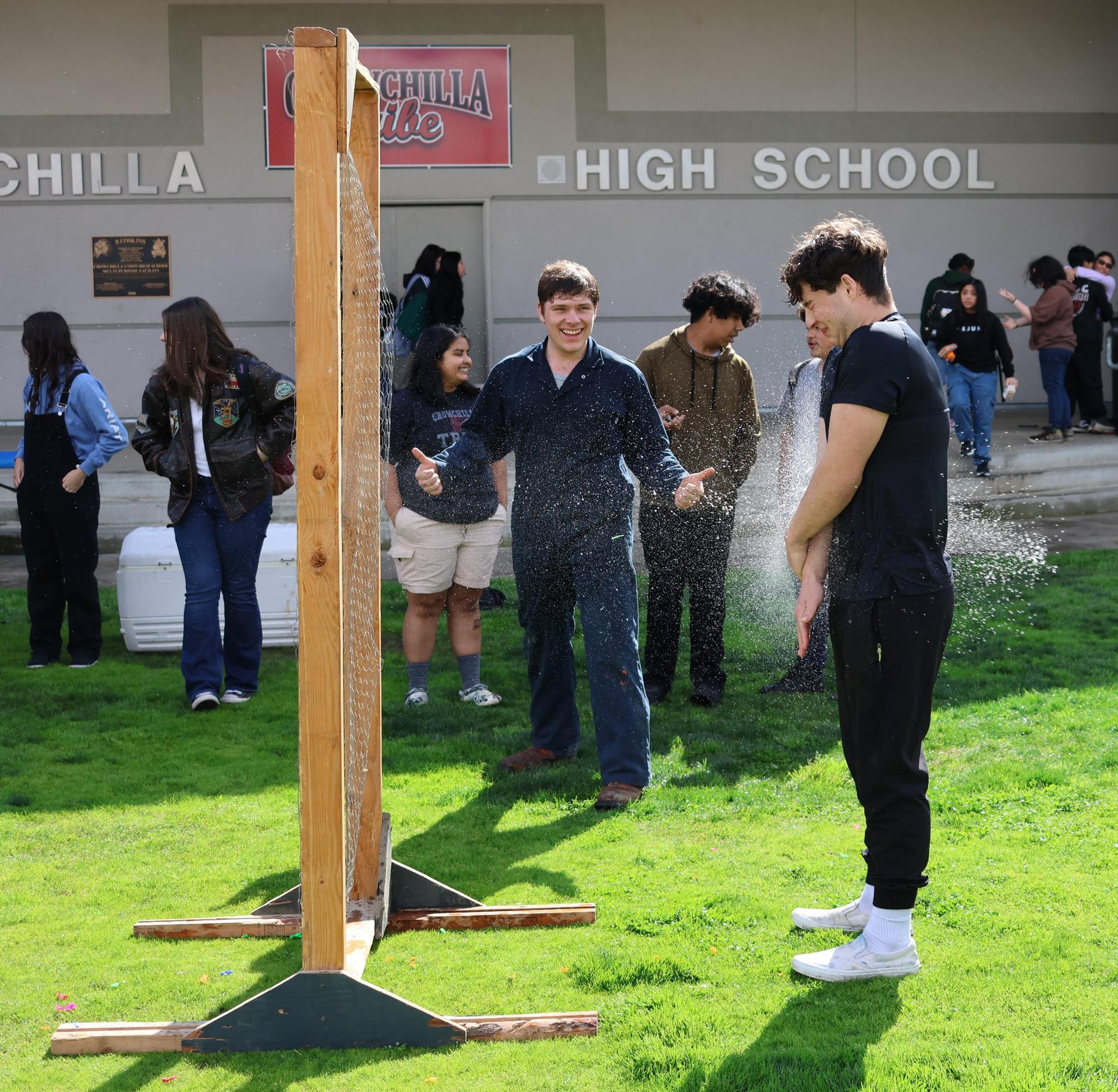 students and staff enjoying the water balloon toss