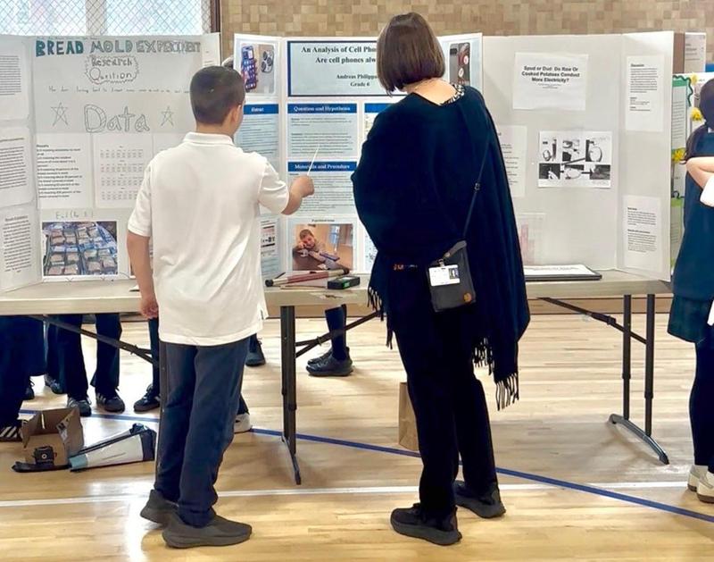 Picture of the week: Mrs. Adams (right) learning about cell phone radiation from Andreas (Left, Grade 6) during the science fair. Thank you to all of the parents that came to support our students and to learn about a great many things!