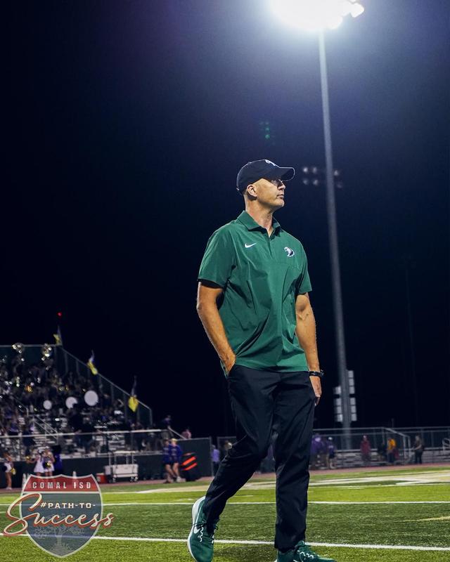 Canyon Lake High School Coach Brian Hooper on the football field after a game.