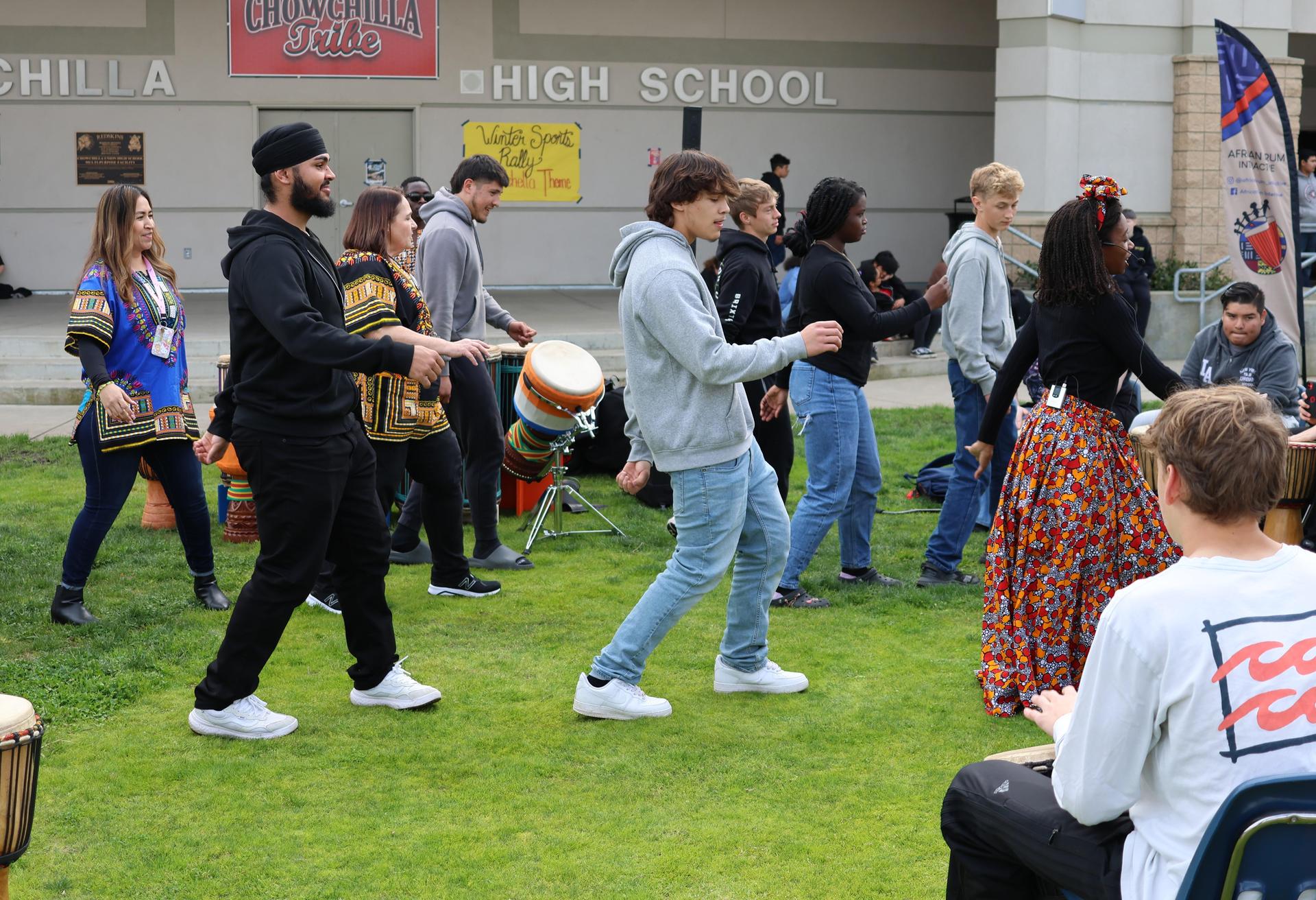 students and staff participating with the African Drum Interactive