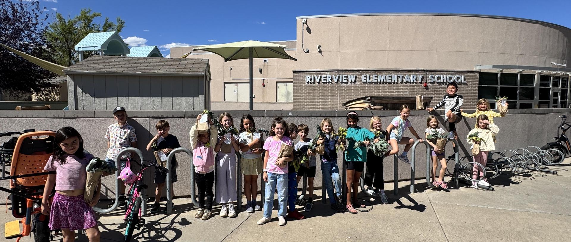 Riverview Green Team stands in front of the bike rack