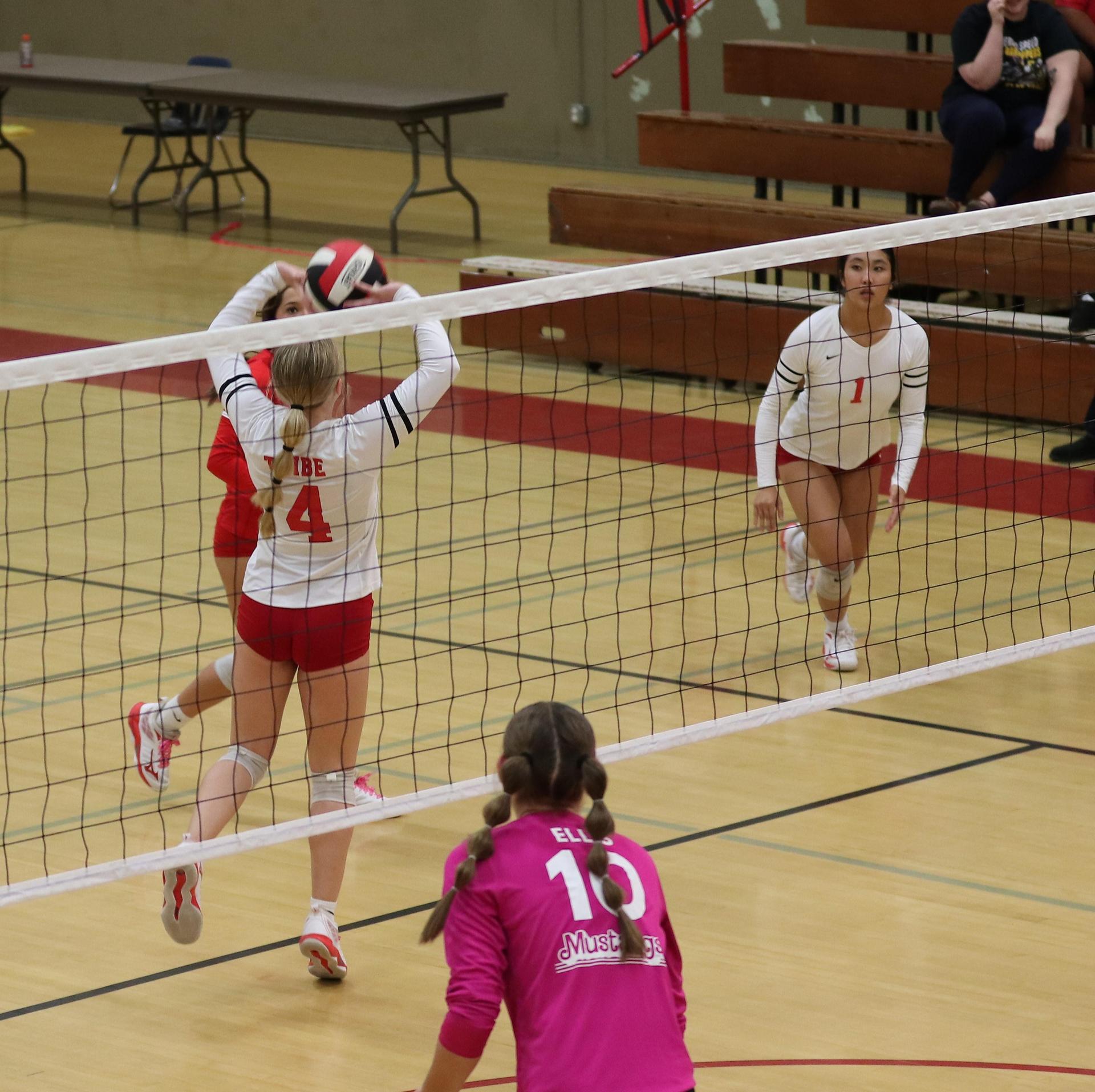 varsity volleyball players in action against Minarets
