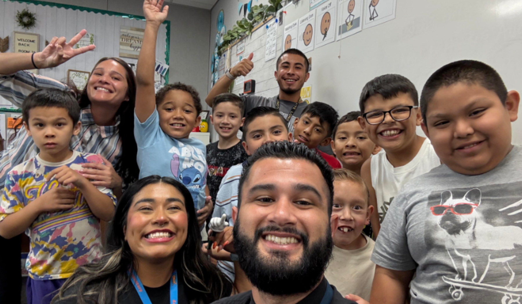 students smiling with educators