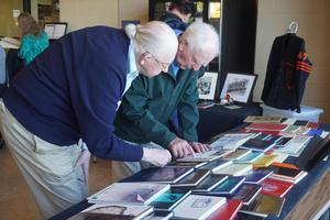 Alumni look through old yearbooks and memorabilia.