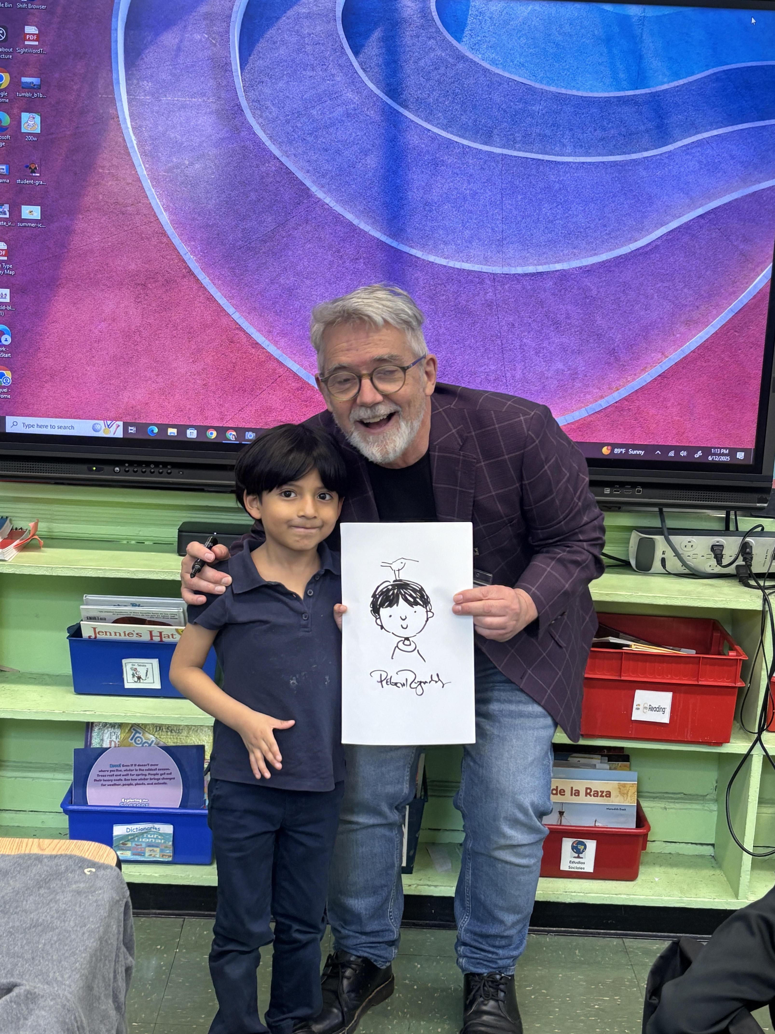author and student holding drawing