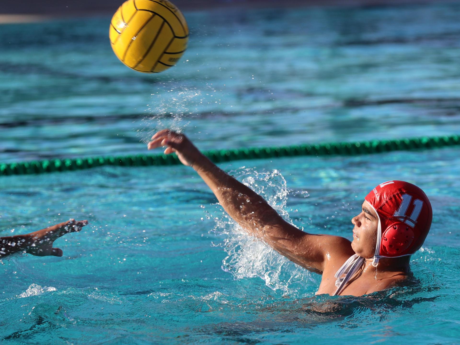 boys water polo players in action against hoover