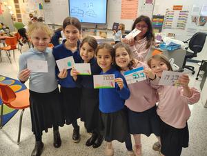 Some second grade students show off their shorashim cards.