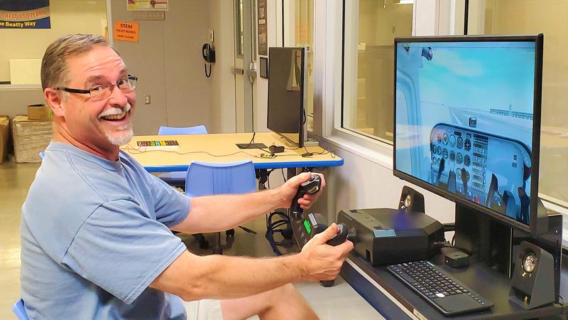 Science and STEM Pilot program teacher John Kopaczewski tests a flight plan from LaGuardia Airport to the Statue of Liberty on one of 10 new flight simulators. Beatty Middle School students will take the flight as part of a new STEM Pilot program.