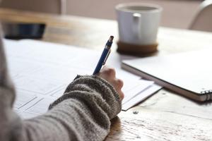 Person writing on a notepad.