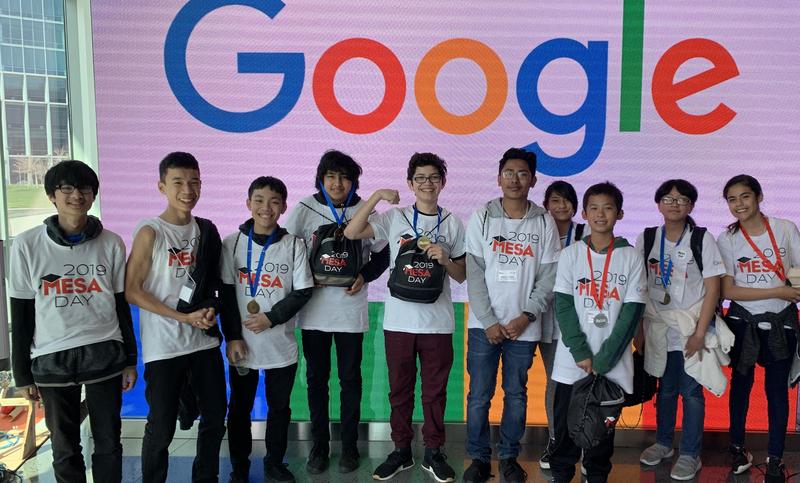 eight students standing in front of Google sign