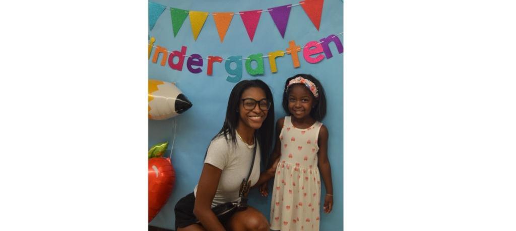 Mom and kindergartner pose for photo.