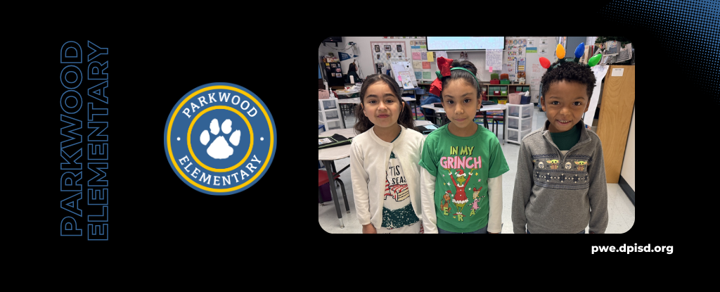 Students dressed in festive outfits posing in a classroom at Parkwood Elementary.