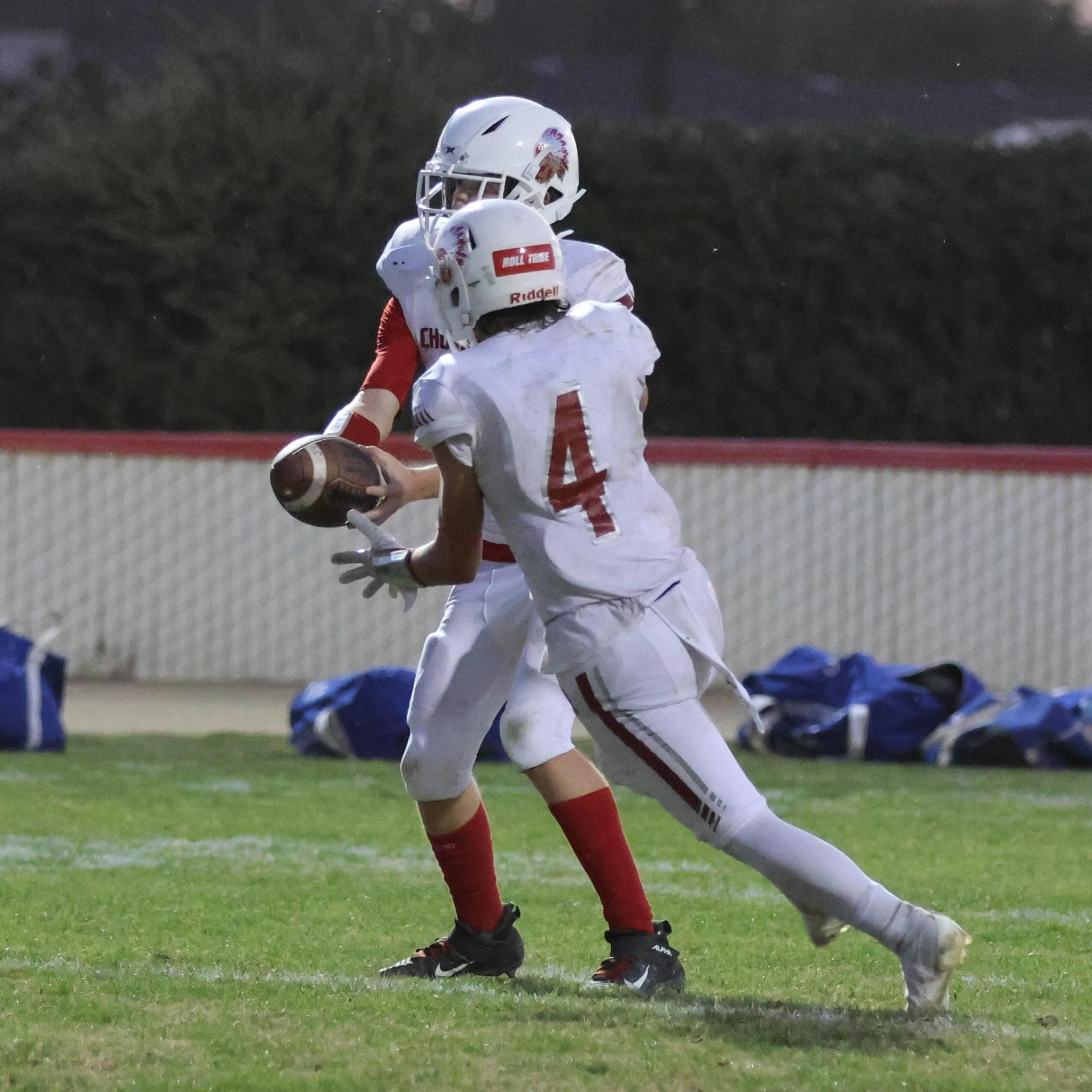 Junior Varsity football players in action against Caruthers