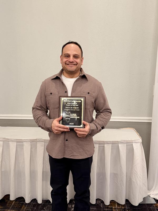 Mitch Stein poses with his Coach of the Year plaque