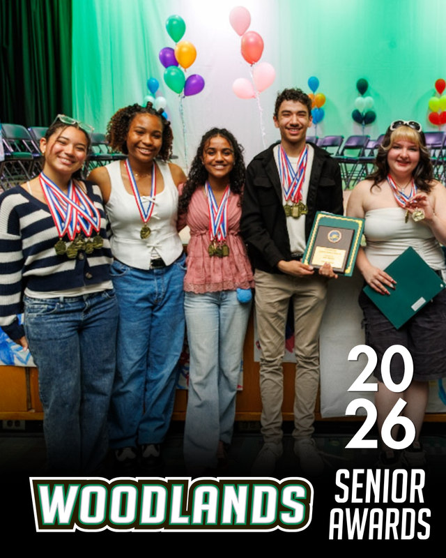 Students pose on stage with award certificates