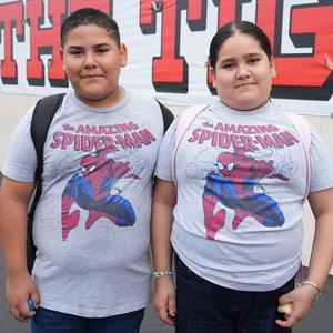 two students dressed alike with Spiderman t-shirts for twin day