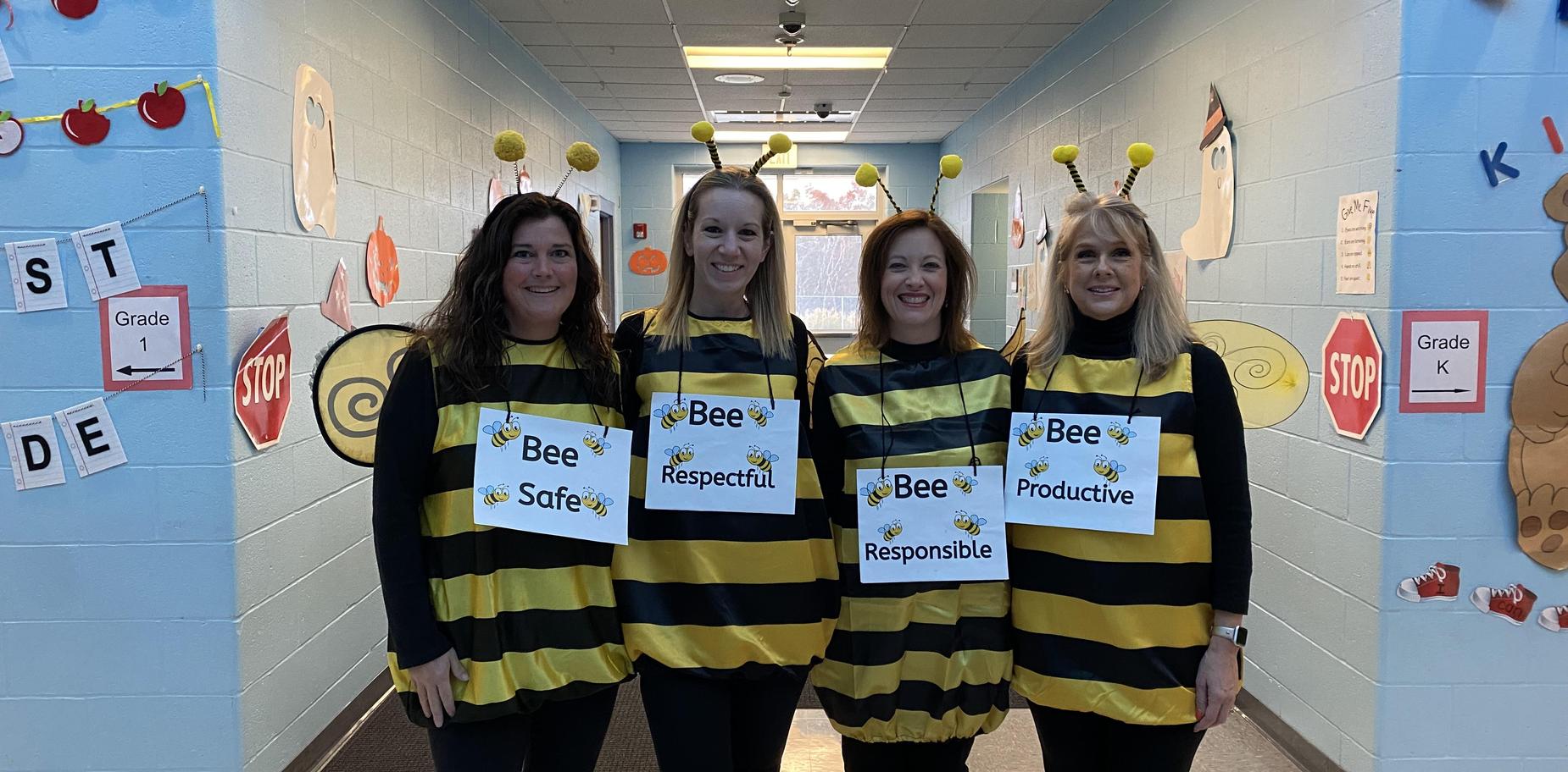 4 teachers wearing bee outfits