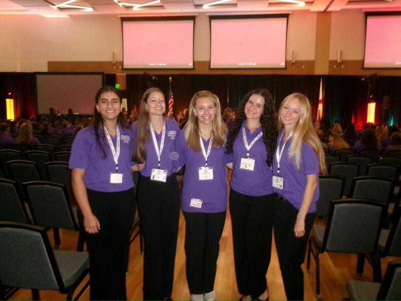 Five smiling teen girls in purple polo shirts on FL Congress Floor