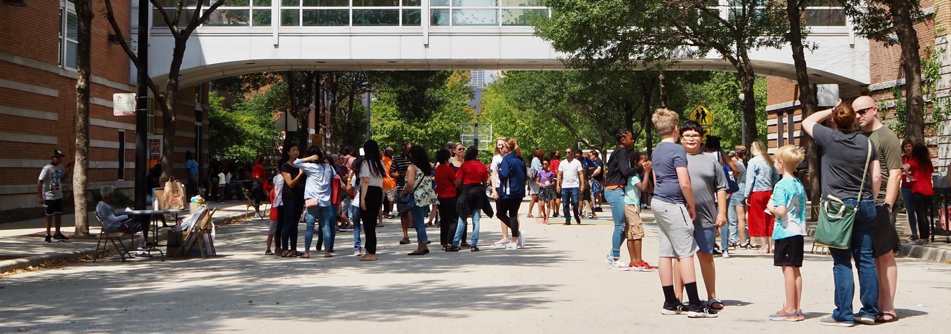 Exterior view of NTA during Familypalooza 2024 with students and families enjoying the event.
