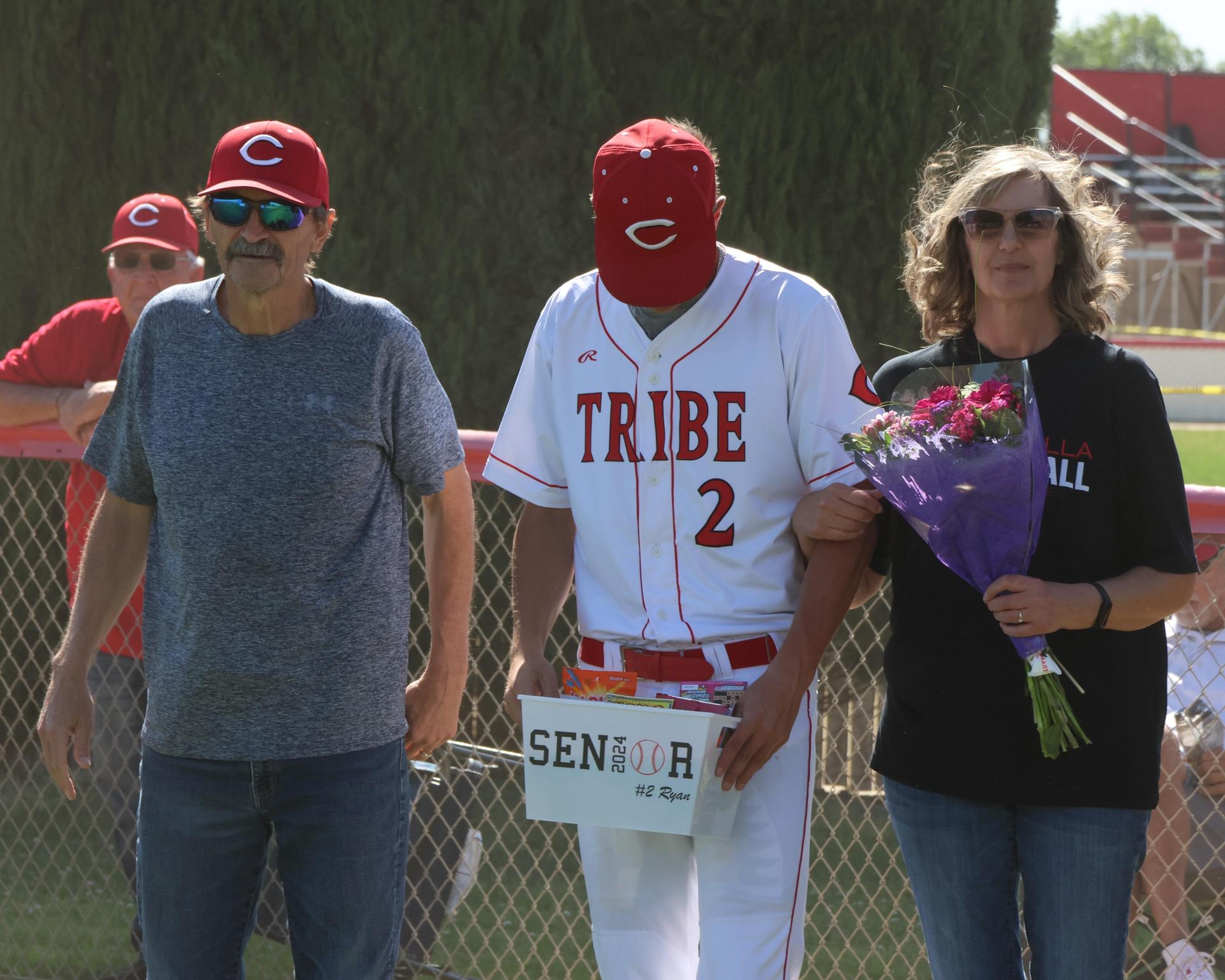 Seniors Posing With Teammates, Coaches, And Family