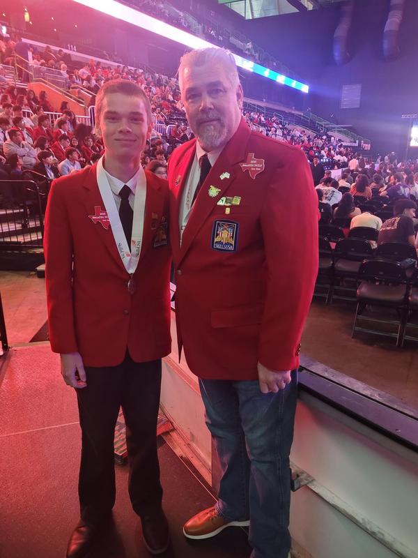 Frenship high school construction student at state competition with the construction teacher.