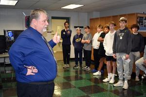 A teacher talks with students