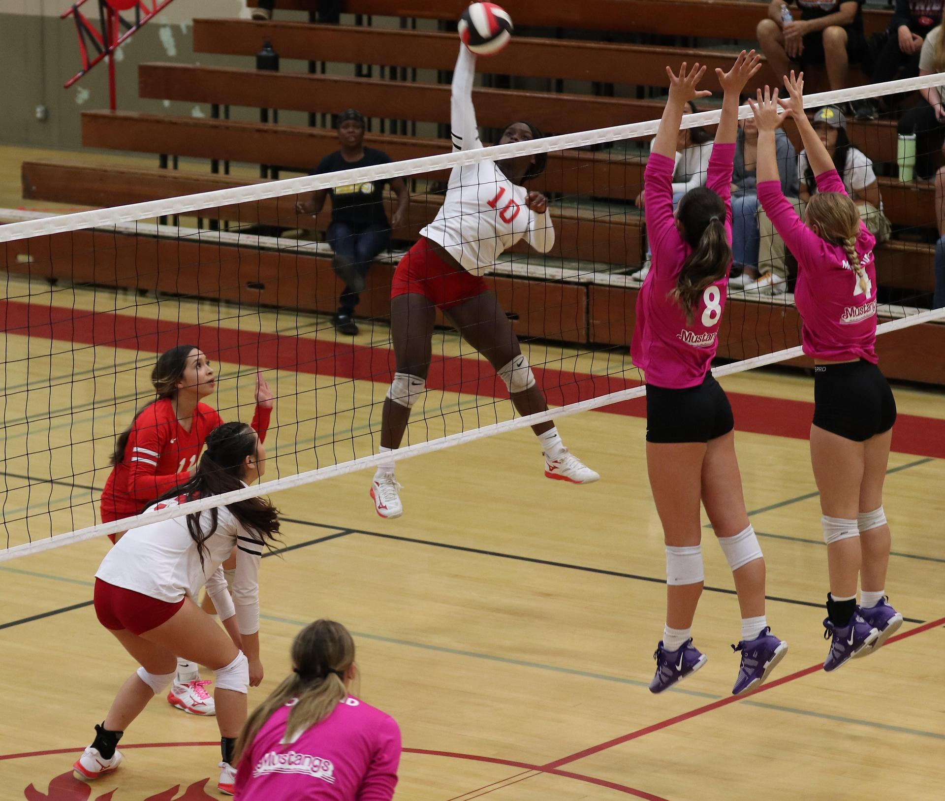 varsity volleyball players in action against Minarets