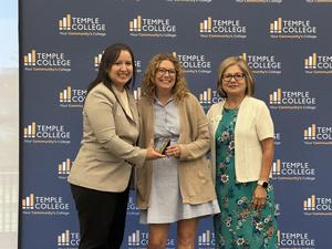 Temple High School's Kristi Burke accepts the award from Temple College administrators