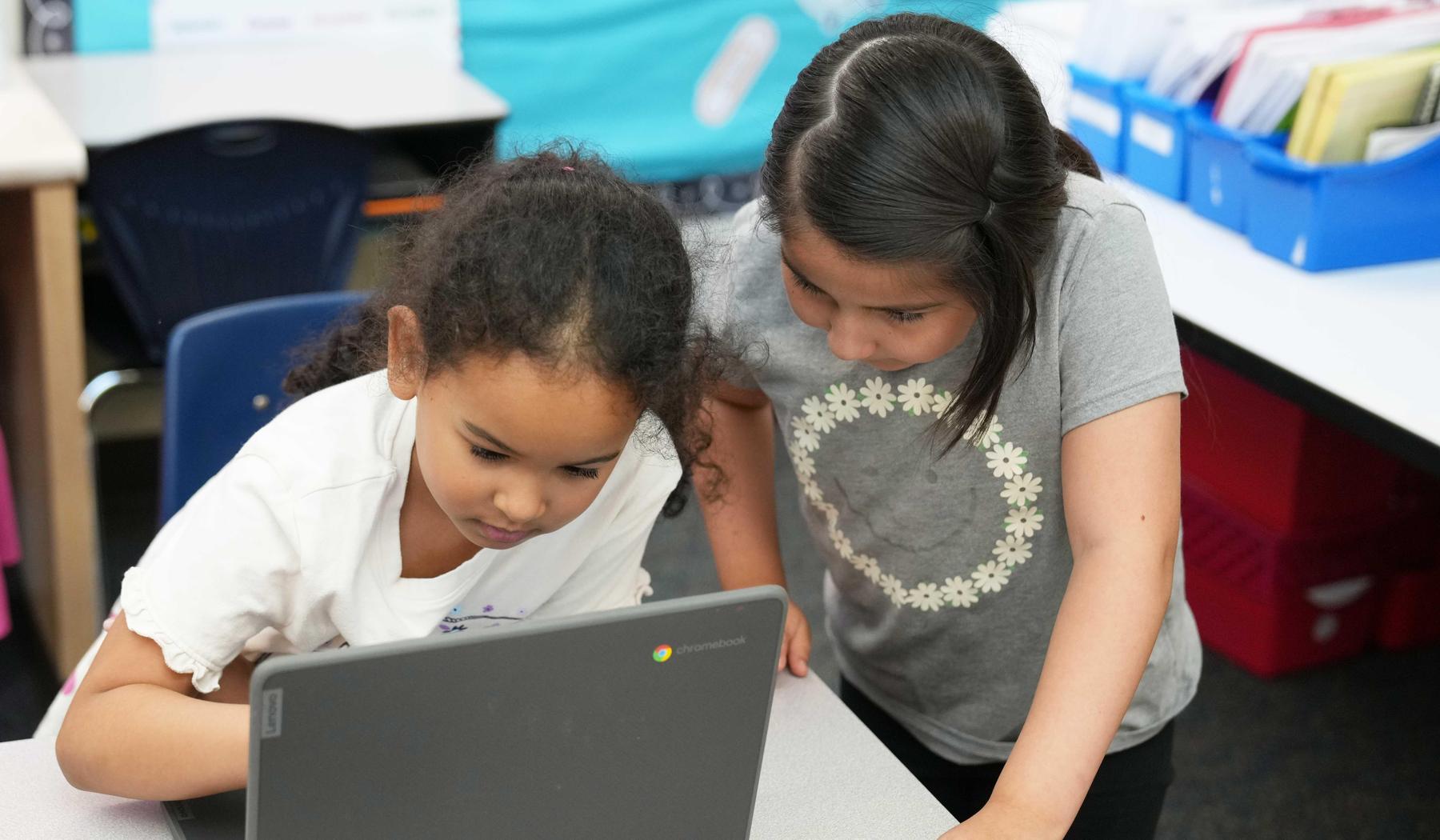 two elementary school girls working on a Chromebook