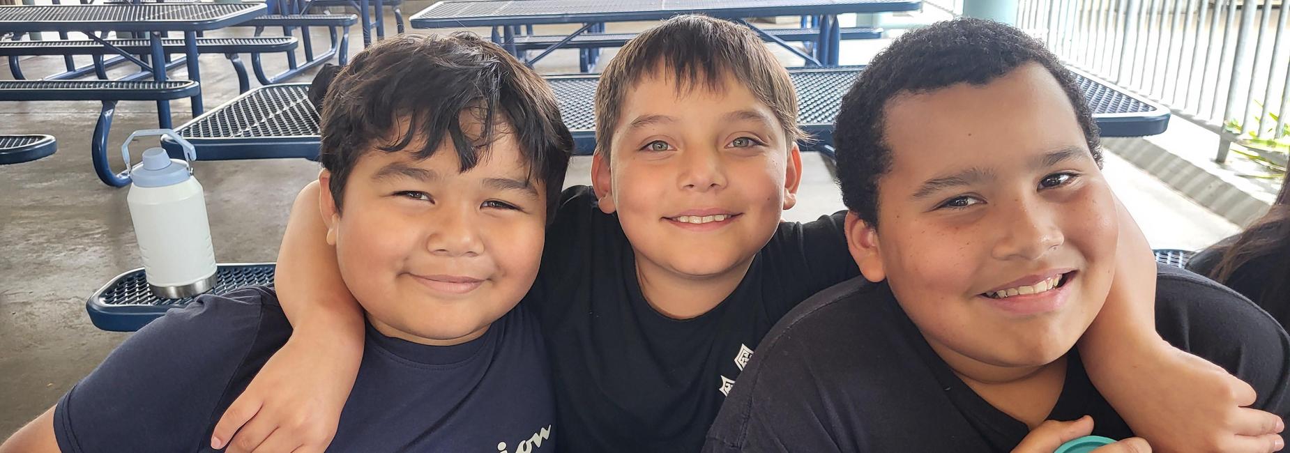 Three boys smiling