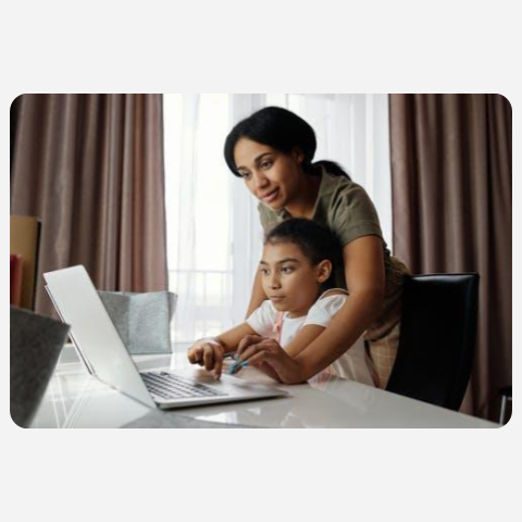 parent and child looking at a computer screen