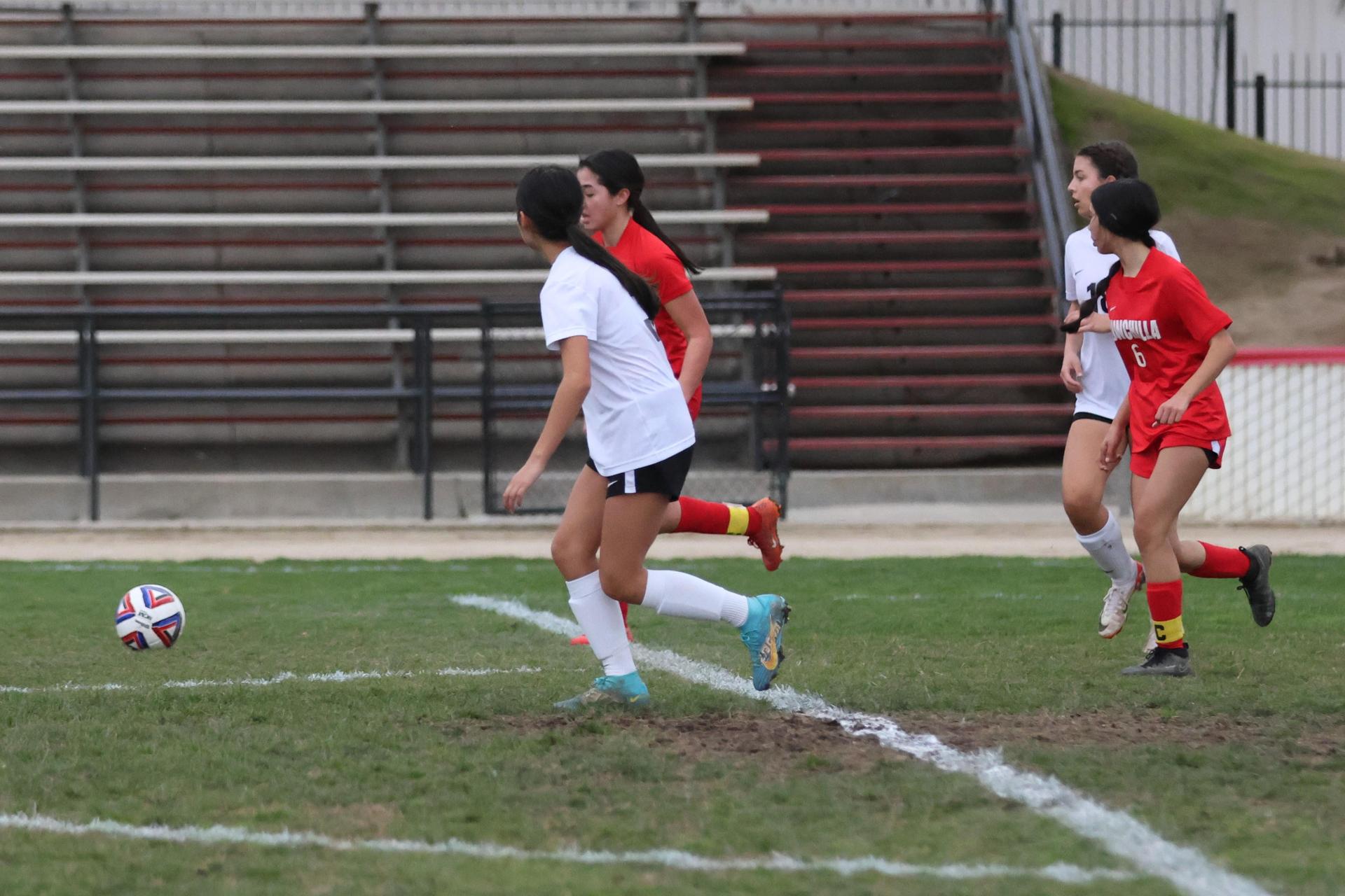 Junior varsity girls playing soccer against liberty