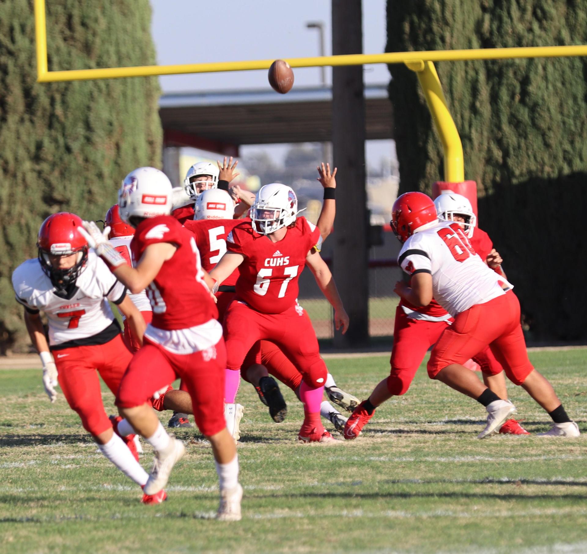 junior varsity football players in action against Fowler