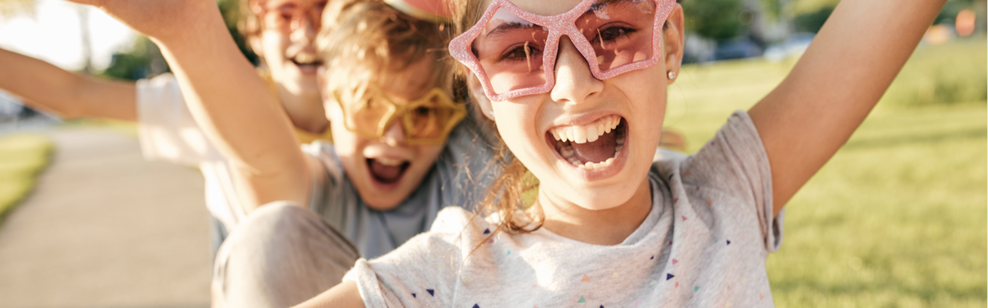 Kids with fun glasses smile with open mouths