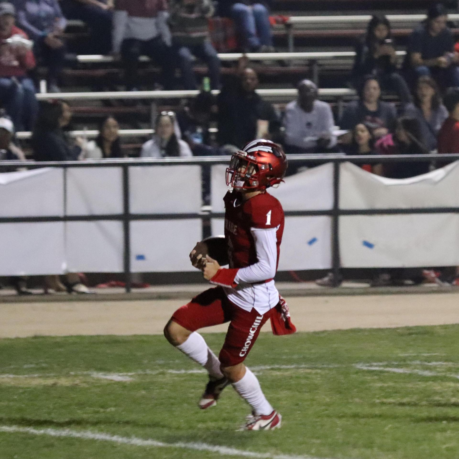 varsity football players in action against Riverdale