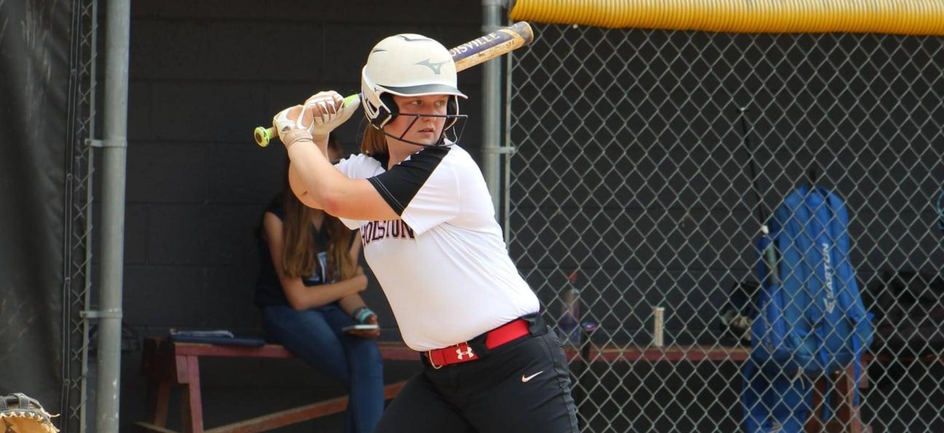 A softball player prepares to hit the ball.