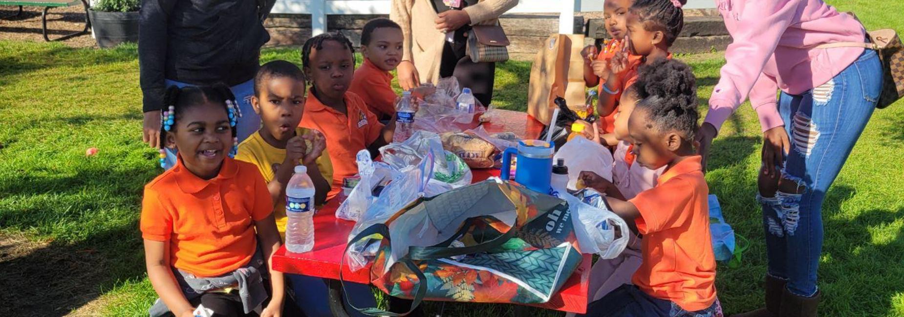 A group of 11 students and faculty enjoying a day outside in nature with animals.