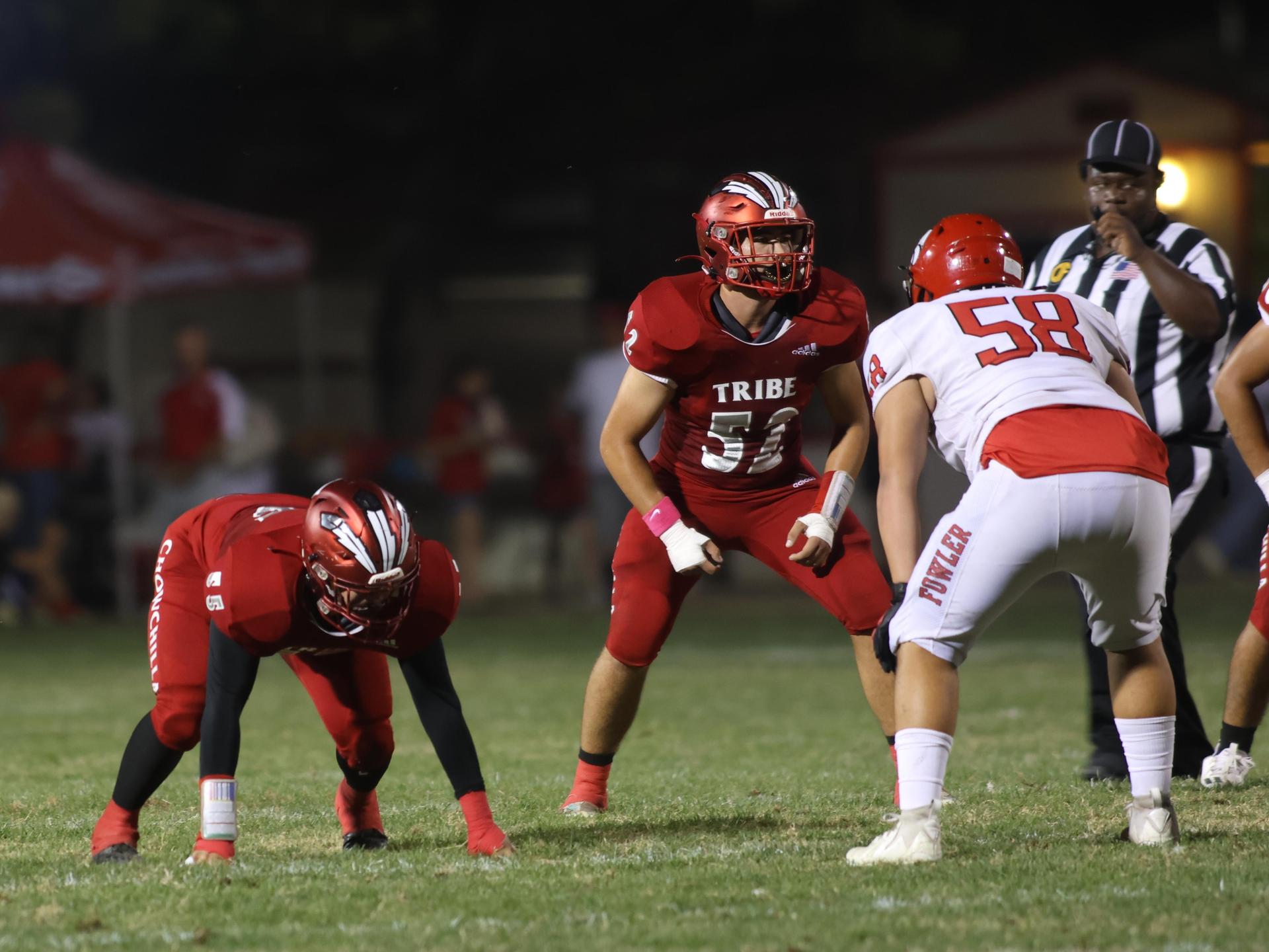 varsity boys playing football against Fowler