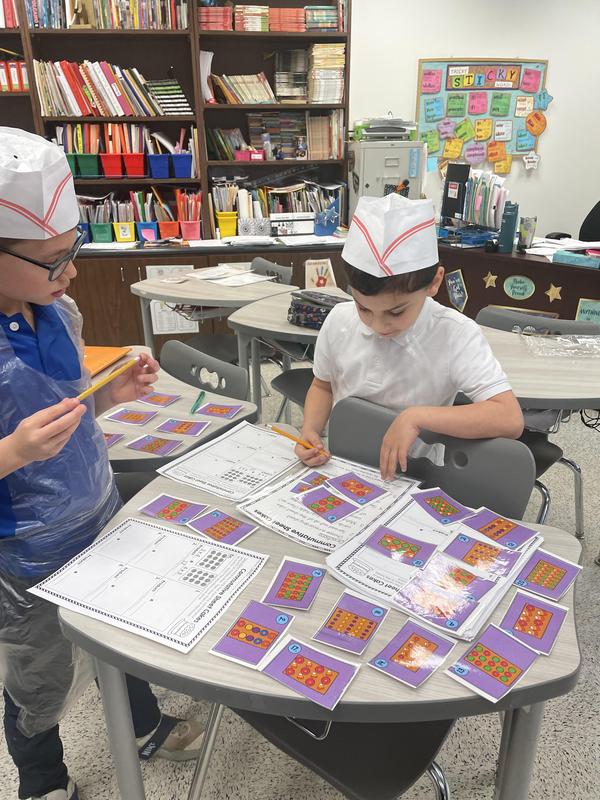 two boys working together at the math  bakery.