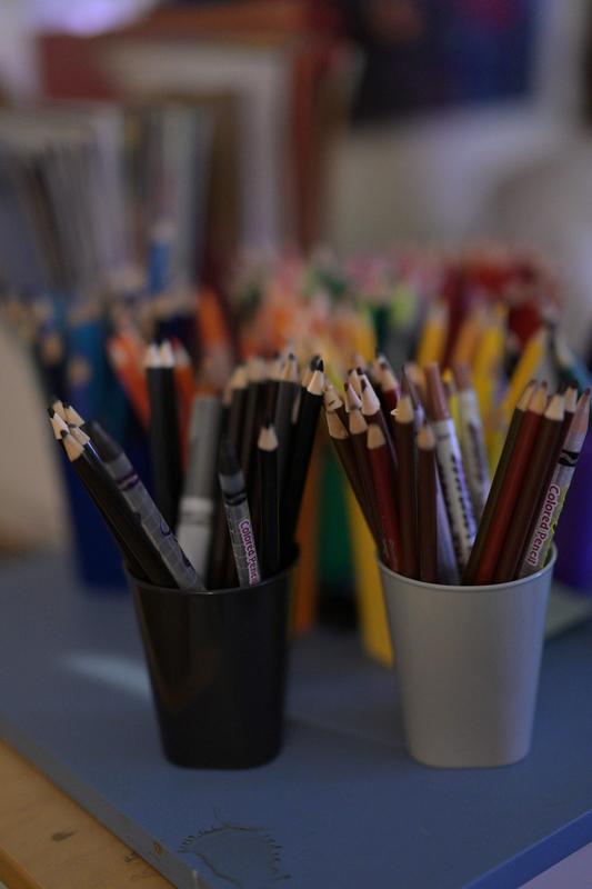cups of colored pencils on a classroom table at Harbor City International School charter school in Duluth
