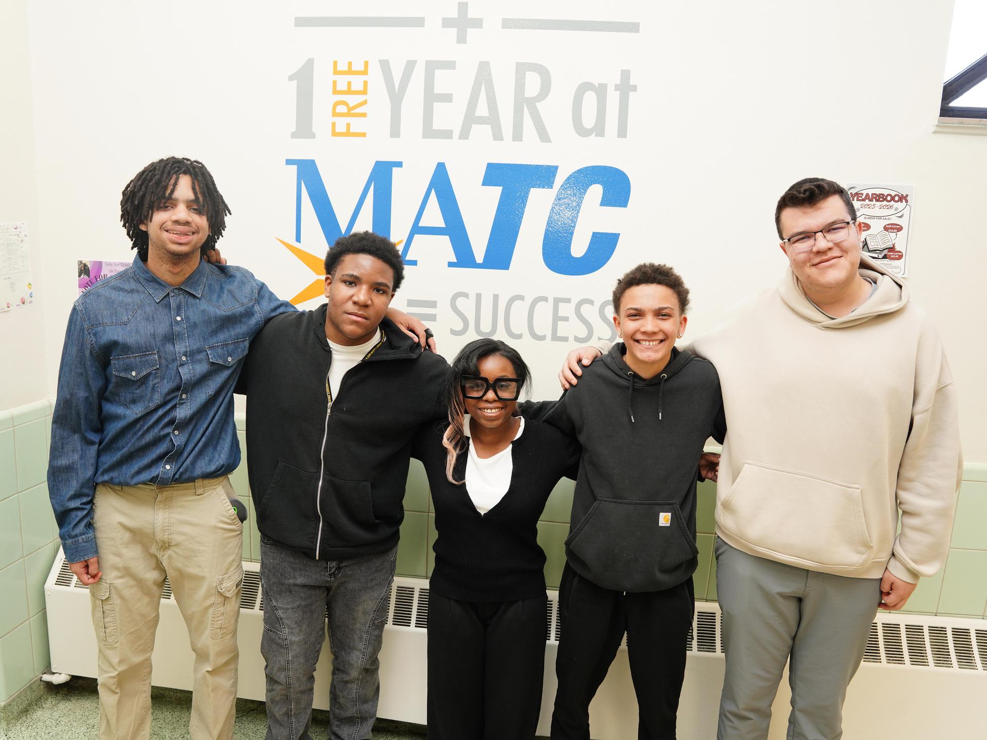 Tenor Cathedral students standing in front of a sign saying MATC.