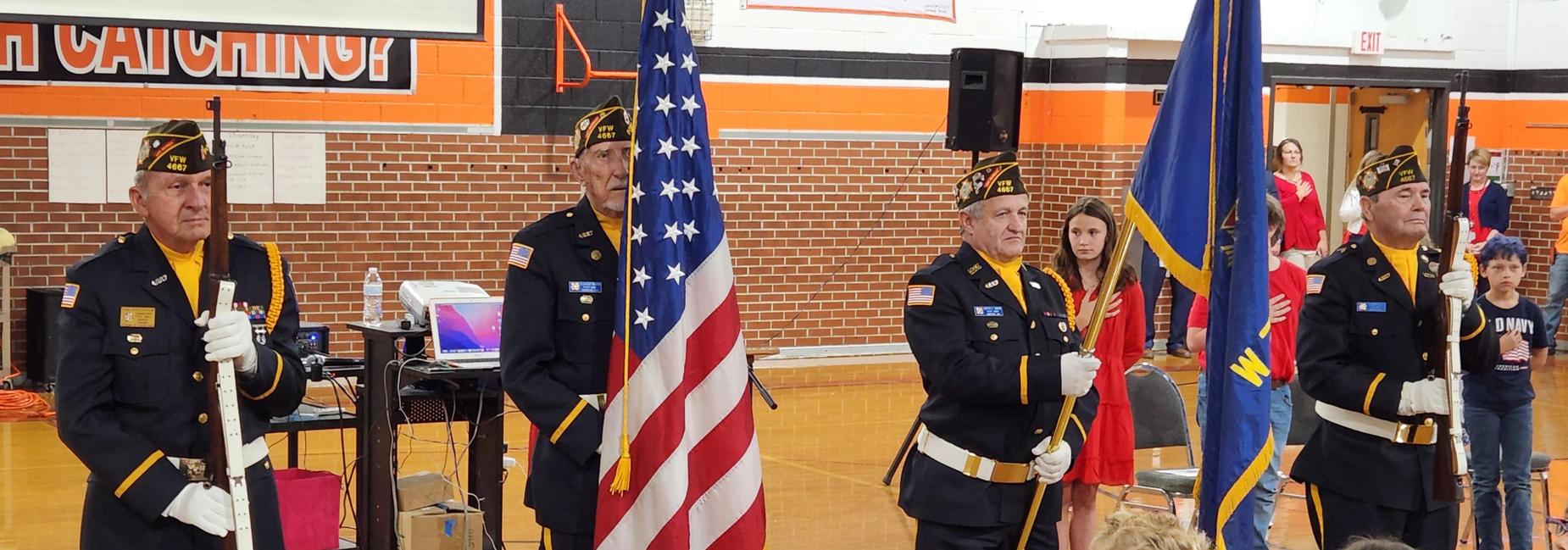 Photo of VFW members presenting the flags during the CES Veteran's Day Assembly