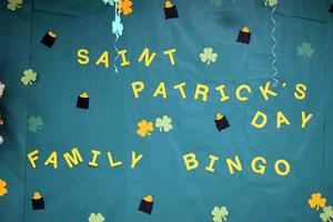 A green bulletin board with the words St. Patrick's Day Family Bingo in yellow.